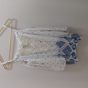 Cold shoulder blouse. Cream with blue floral design